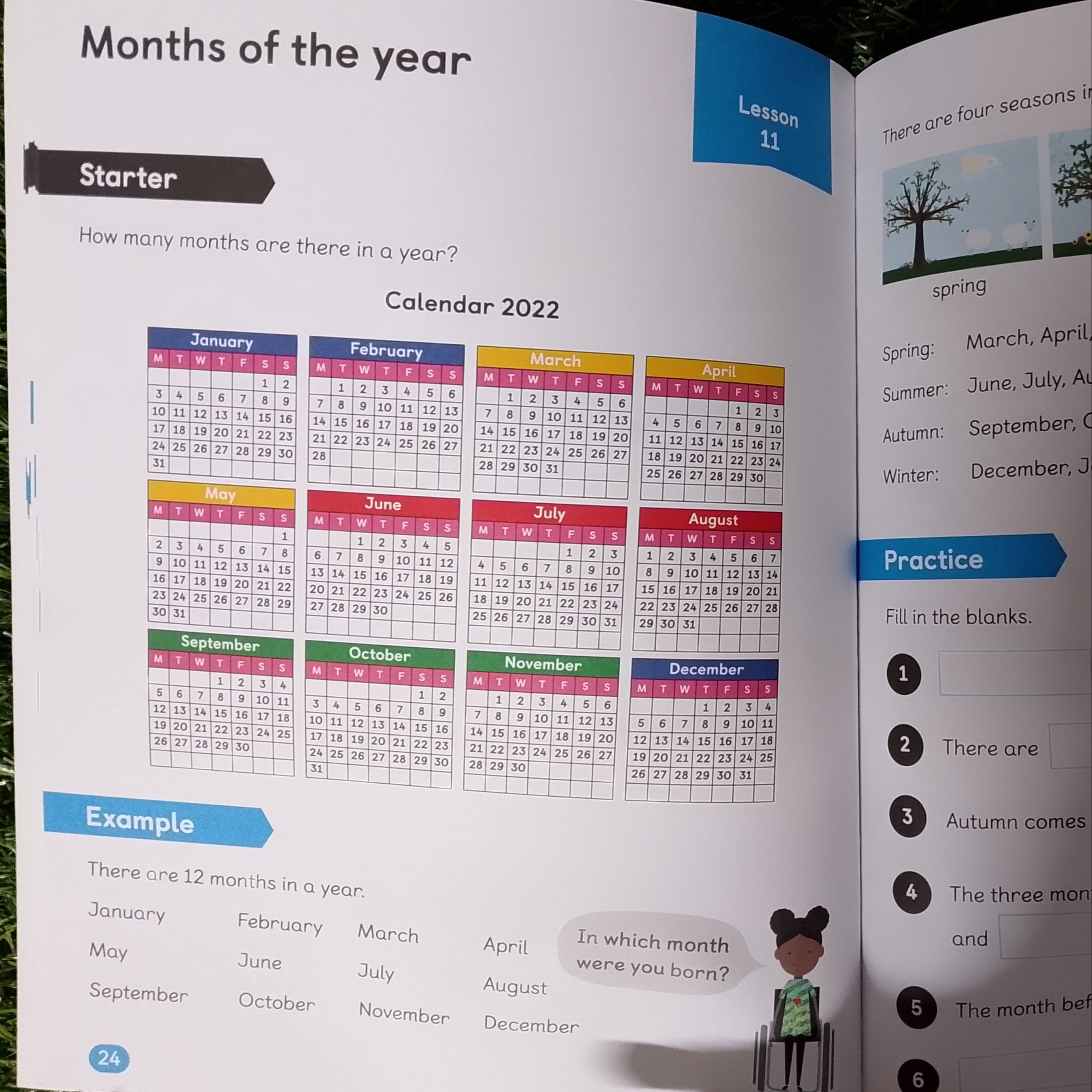 Open book showing educational content on months of the year with a calendar on grass.